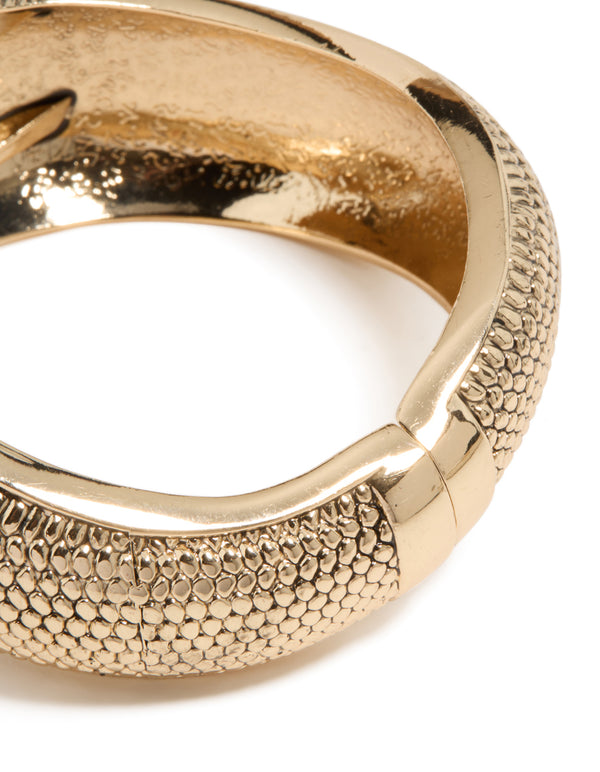 Discover a gold dotted boho hinged statement bangle close up view