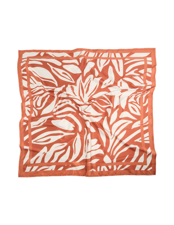 Showcasing a white and orange lined fabric scarf with abstract print in coral and ivory front view