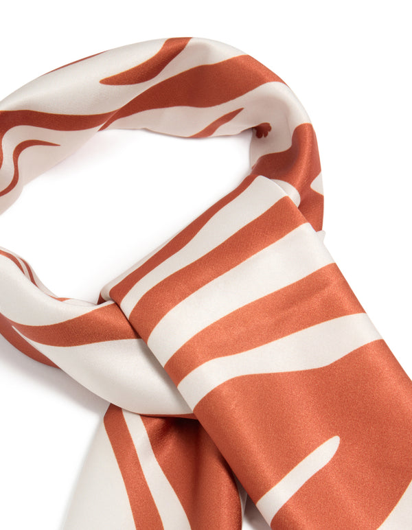 Elegantly designed white and orange lined fabric scarf with abstract print in coral and ivory detail view