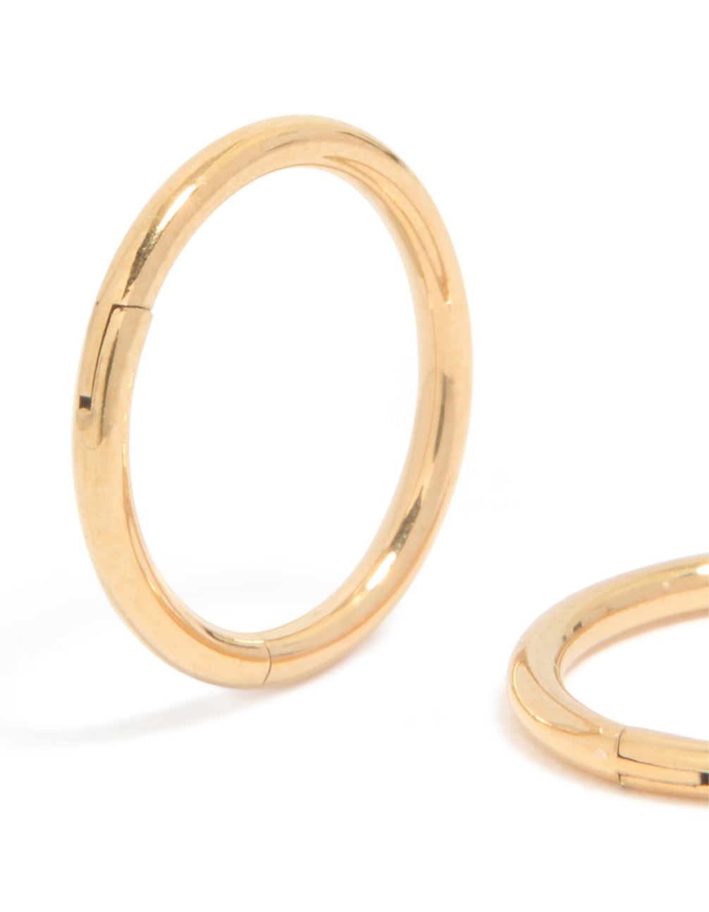 Featuring gold plated surgical steel 8 MM thick sleeper earrings with hoop closure close up view