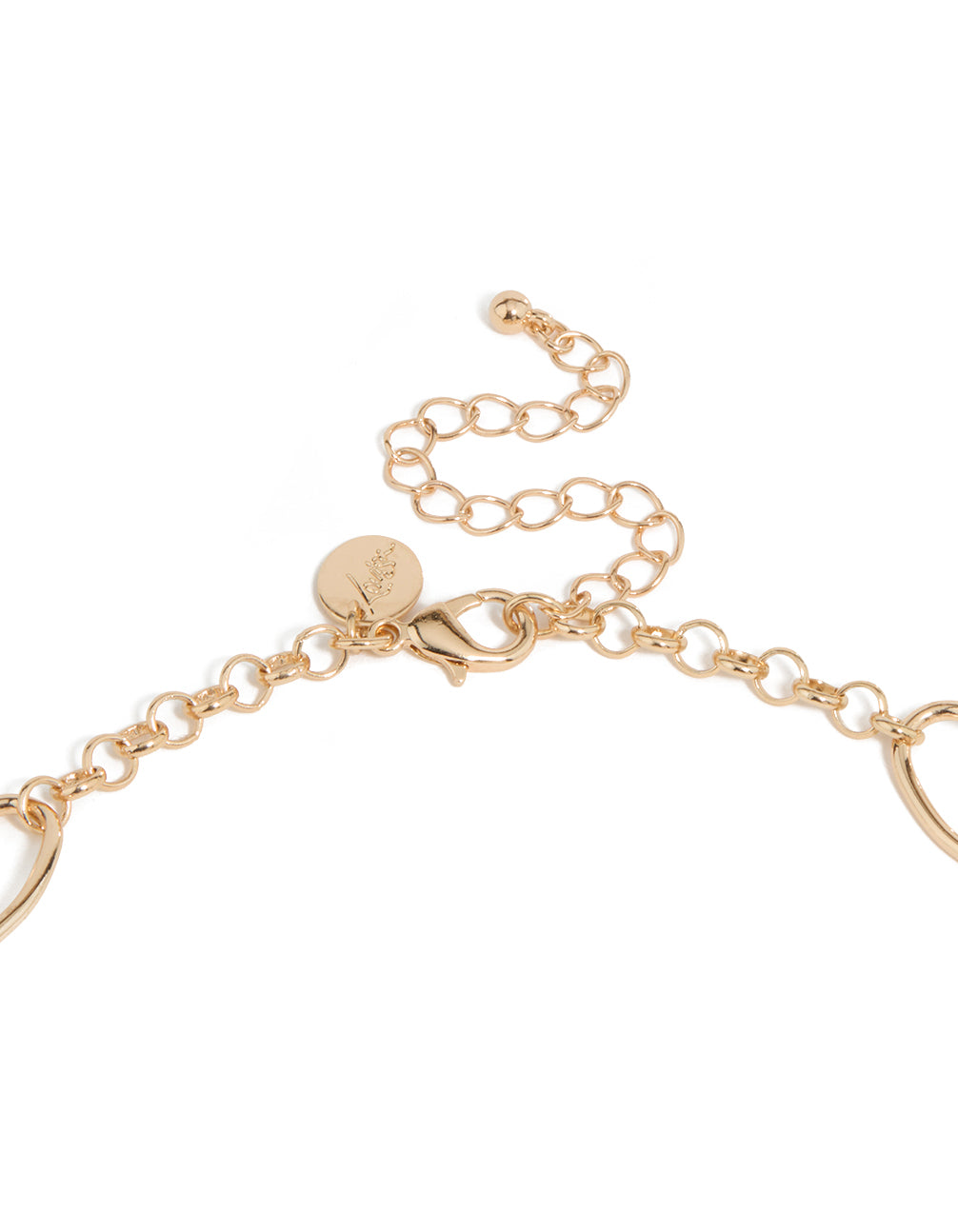 Highlighting the long beaded necklace with balls, beads, charm accents and tassel fringe in gold statement style clasp detail view