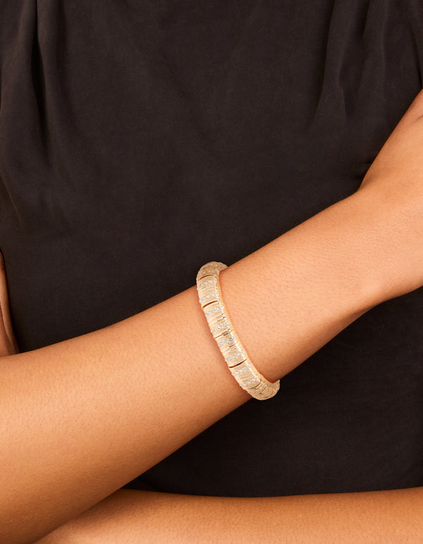 Elegant gold ribbed diamante stretch bracelet on wrist view