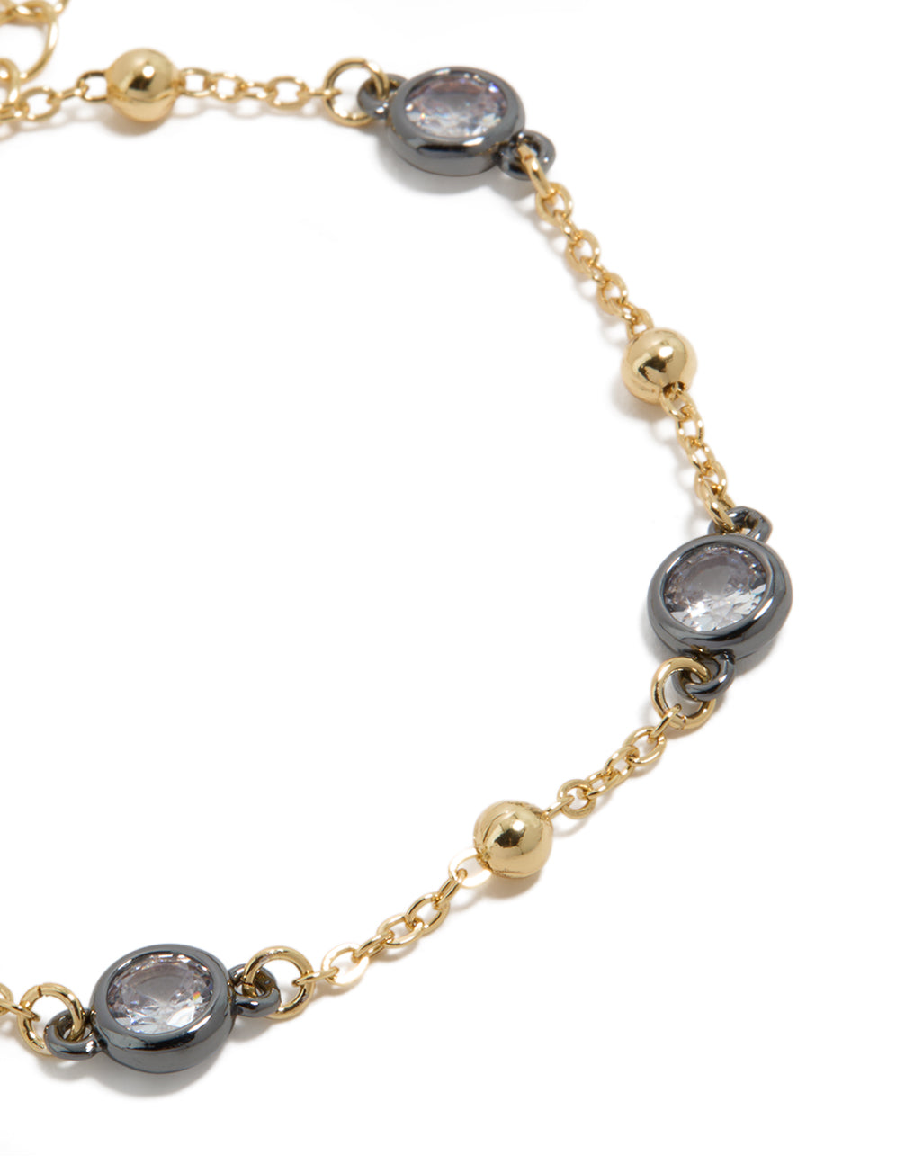 Bracelet featuring mixed metal, cubic zirconia stones set in grey bezels alternating with gold plated balls on delicate chain close up view