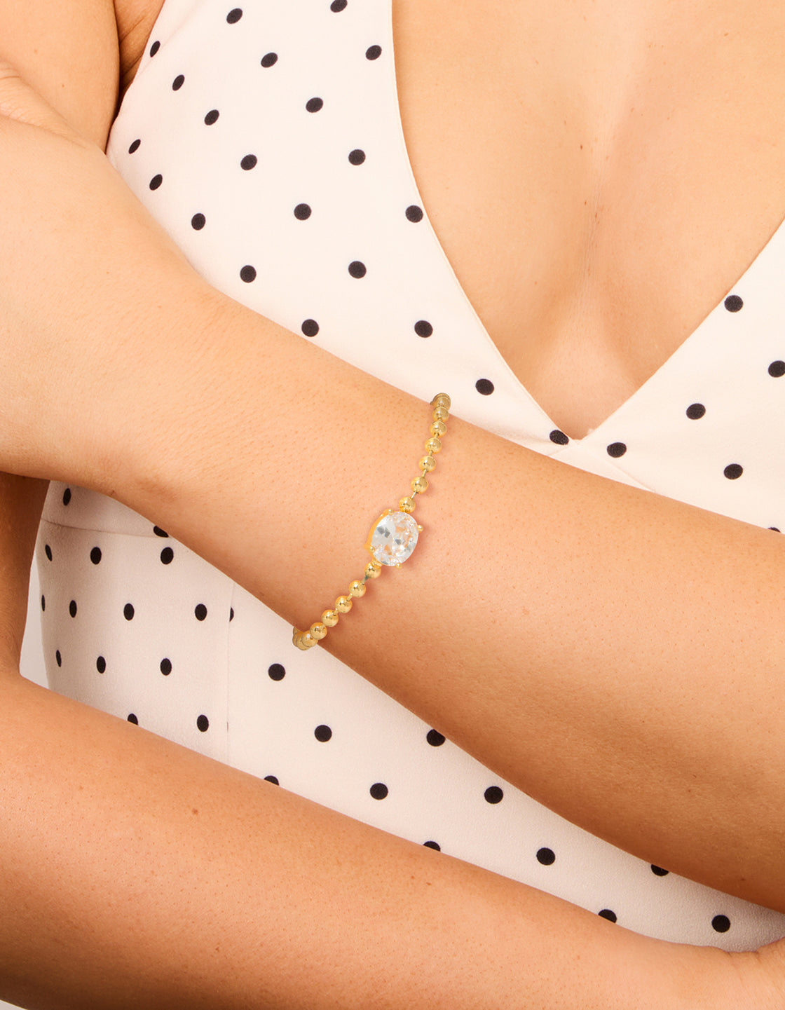 Elegantly designed ball and cubic zirconia oval toggle chain bracelet in gold plated on wrist view