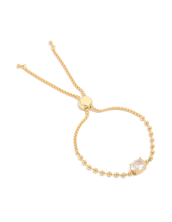 Elegant gold ball and cubic zirconia oval toggle chain bracelet featuring gold plated metal with clear accents front view