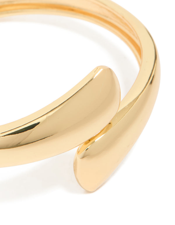 Detailed view of gold plated flat teardrop hinged bangle highlighting smooth finish and design close up view