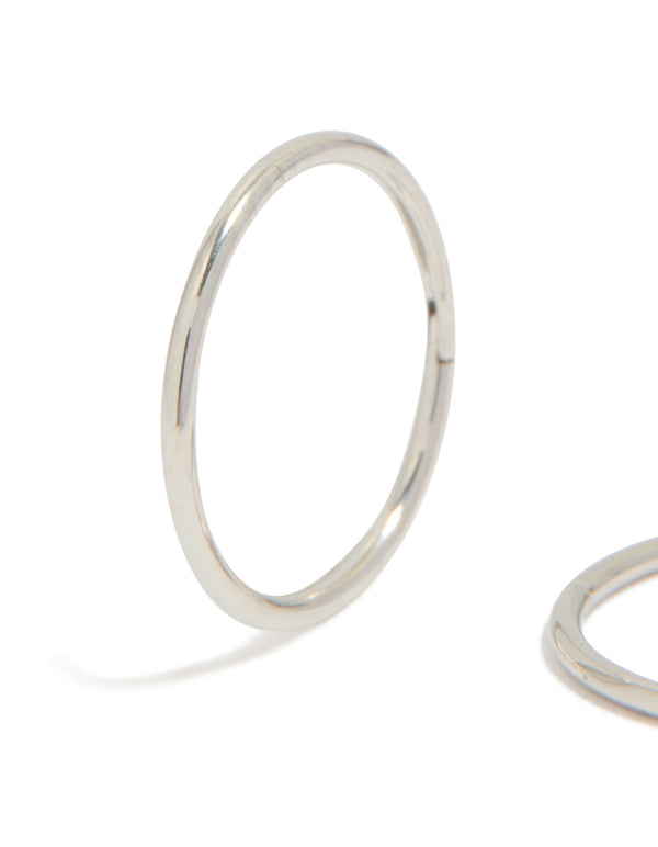 Showcasing kids surgical steel sleeper earrings with dainty, hoop closure in silver close up view