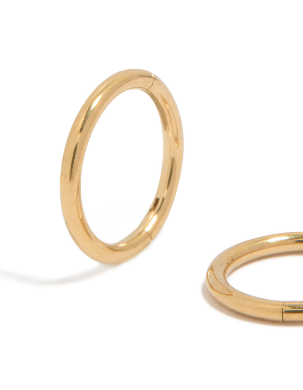 Showcasing kids surgical steel sleeper earrings with gold plated finish highlighting polished texture close up view