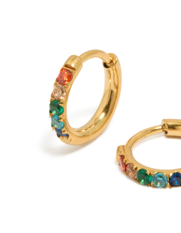 Featuring kids gold plated surgical steel rainbow coloured cubic zirconia sleeper hoop earrings in red, green and blue close up view
