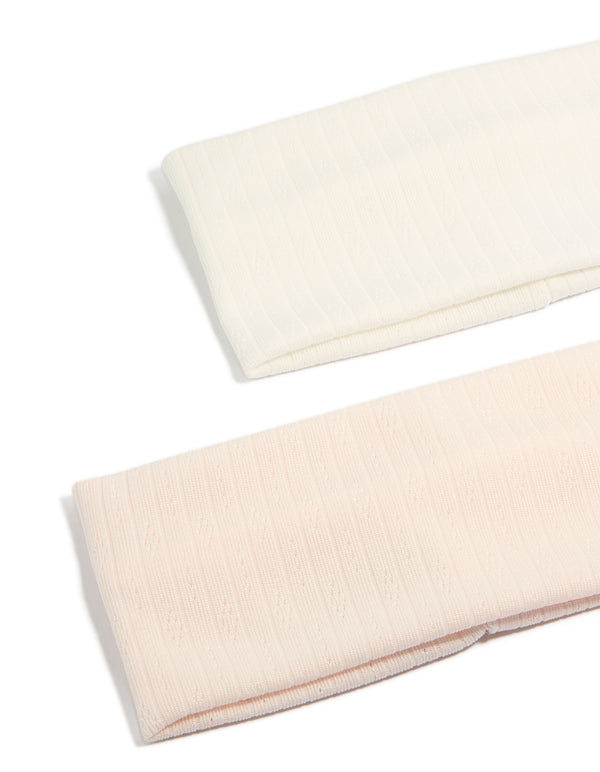 Featuring solid pointelle fabric stretch headbands in a 2-pack with ivory and pink colorways detail view