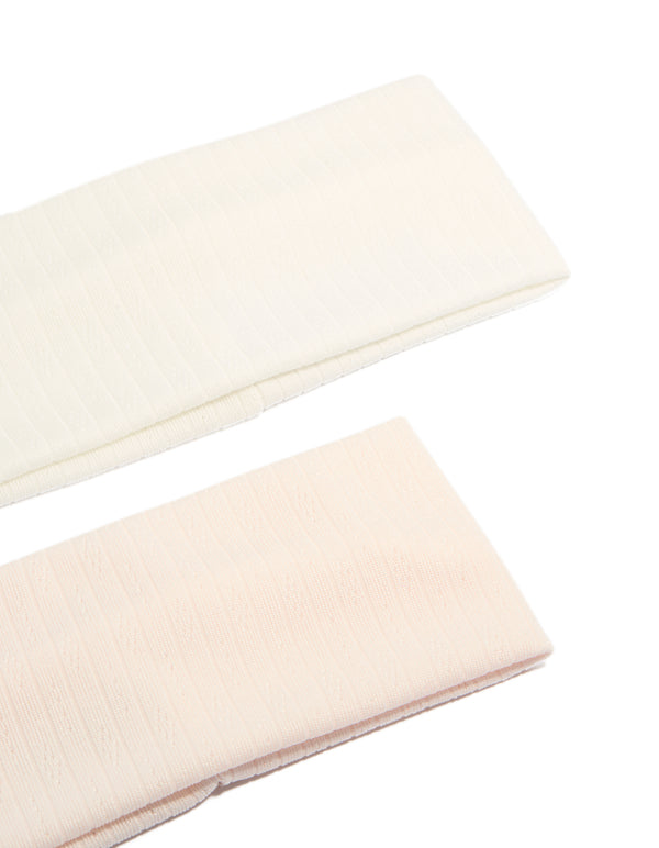 Featuring solid pointelle fabric stretch headbands in a 2-pack with ivory and pink colorways detail view