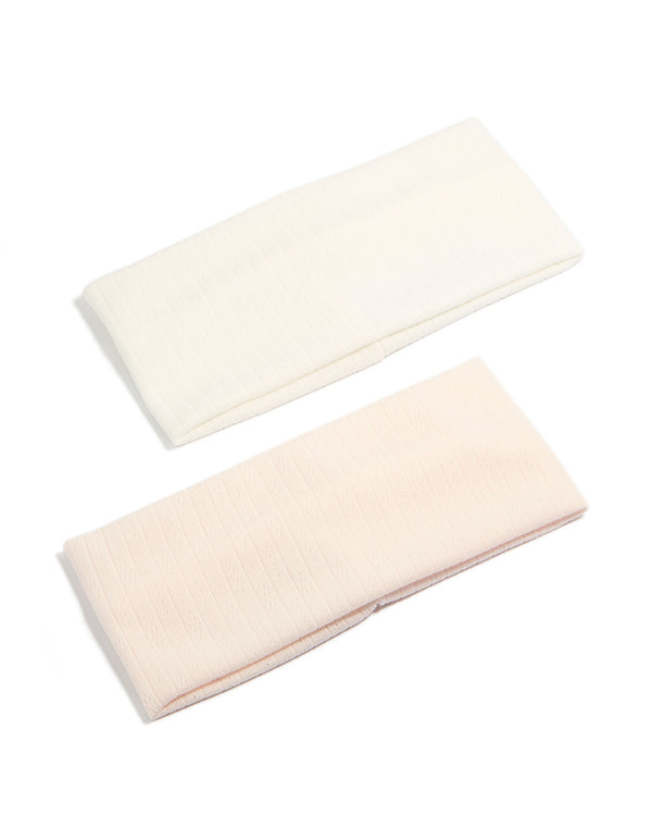 Discover solid 2-pack ivory and pink stretch headbands front view