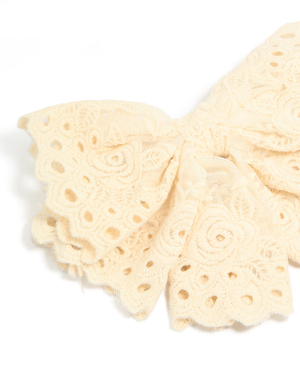 Featuring cornsilk broderie triple layered fabric bow hair clip with floral accents side view