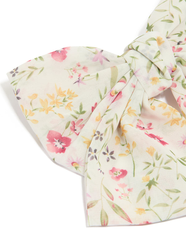 Designed with a bow clip featuring floral print with leaf accents in ivory, pink, light goldenrod yellow, and olive detail view