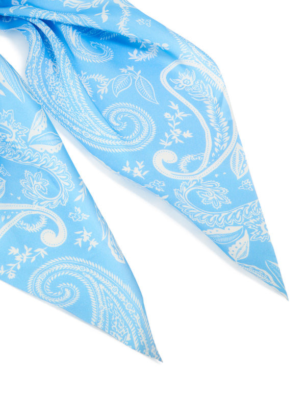 Crafted from light blue fabric, this paisley scarf scrunchie features leaf designs in white detail view