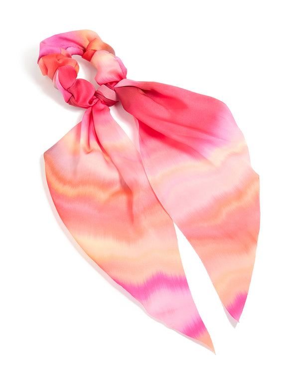 Discover this statement scarf scrunchie featuring tie-dye print in hot pink, coral, and peachpuff tones with long strap front view