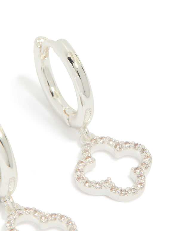 Highlighting silver plated cubic zirconia flower huggie drop earrings in dainty hoop closure post detail view
