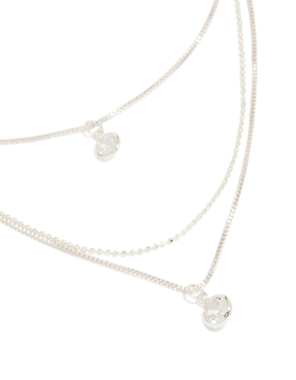 Showcasing a triple-layered drop necklace with beads, round-cut cubic zirconia, crafted from silver-plated material in a silver color close up view