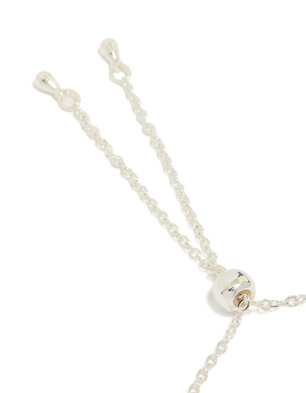 Designed with a silver plated blue cubic zirconia large bezel trio toggle bracelet featuring statement closure detail view