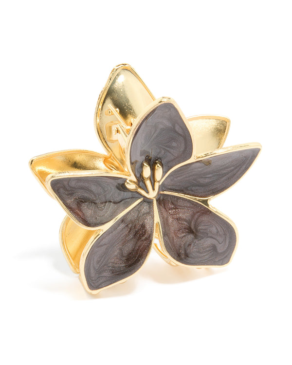 Featuring a floral frangipani design, this enamel claw clip showcases marbled brown in gold side view