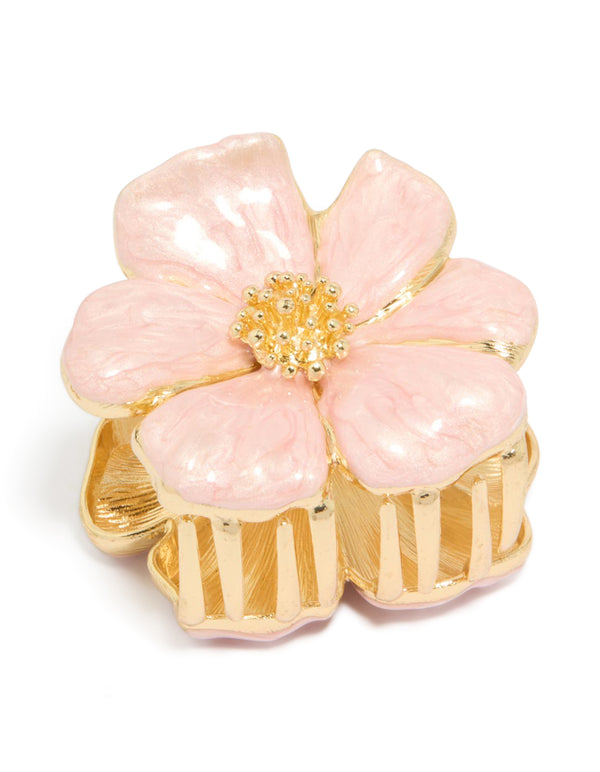 Showcasing a floral enamel blossom hair claw clip detailing in light pink and gold front view