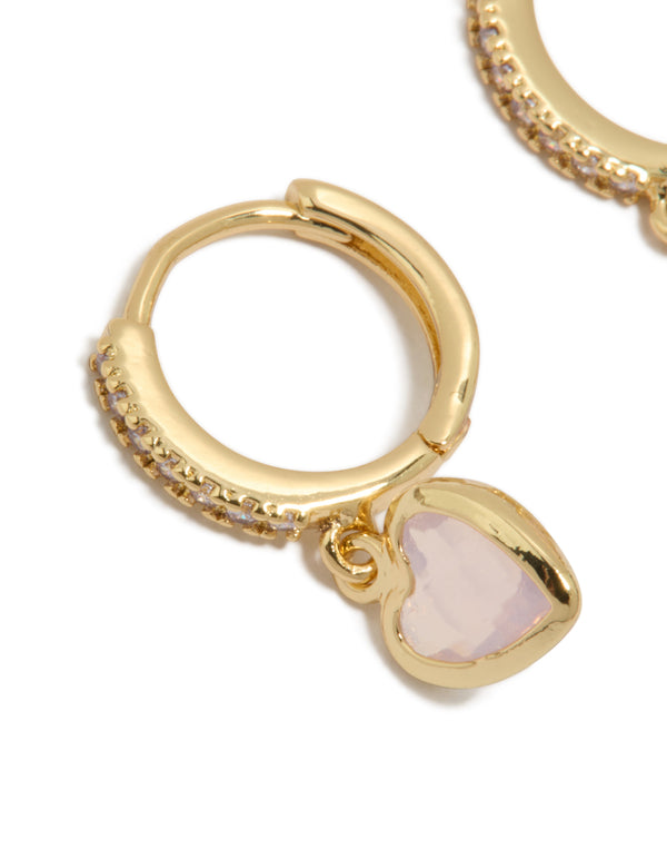Crafted from gold plated material, these dainty cubic zirconia and pink heart drop huggie earrings are presented in a close up view