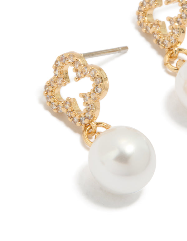 Beautifully crafted floral pearl cubic zirconia outlined flower gold plated earrings in white and gold close up view