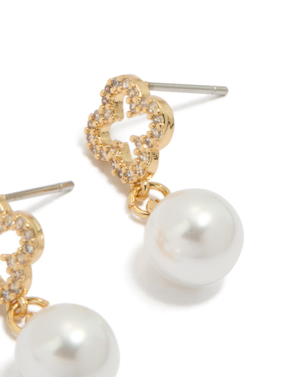Explore the floral pearl cubic zirconia outlined flower gold plated earrings in white and gold post detail view