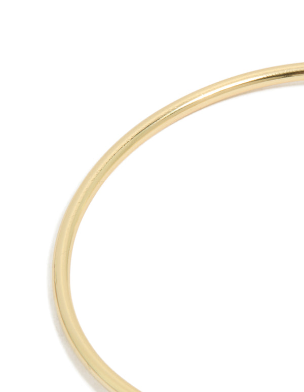 Highlighting a floral statement wrist cuff in gold plated metal with cubic zirconia close up view