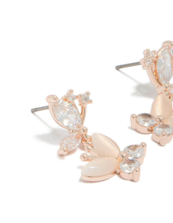 Elegant drop earrings with double butterfly charm featuring cubic zirconia in rose gold plated finish close up view