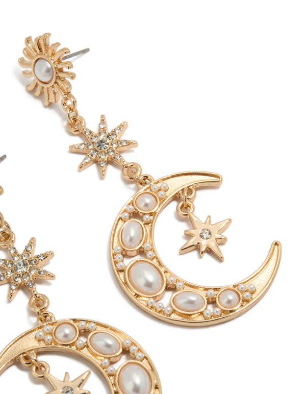 Highlighting gold pearl celestial drop earrings featuring charm design post detail view