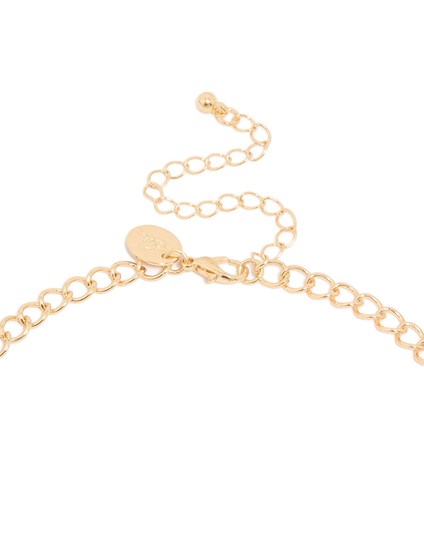 Featuring a gold mesh bib tassel necklace with statement design clasp detail view