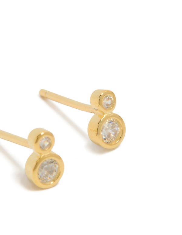 Highlighting dainty stud earrings crafted from gold plated sterling silver with cubic zirconia in a double bezel setting post detail view