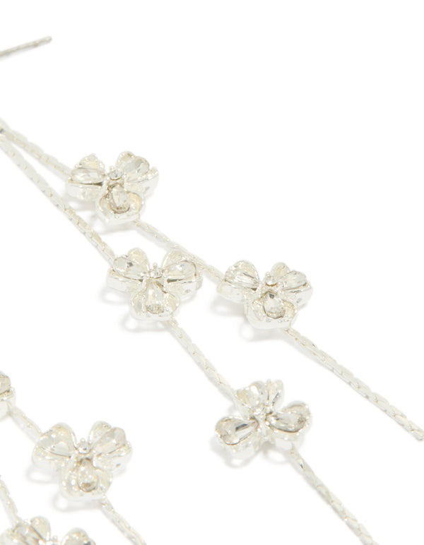 Presenting dainty silver floral drop earrings with delicate flower and clear accents detail view