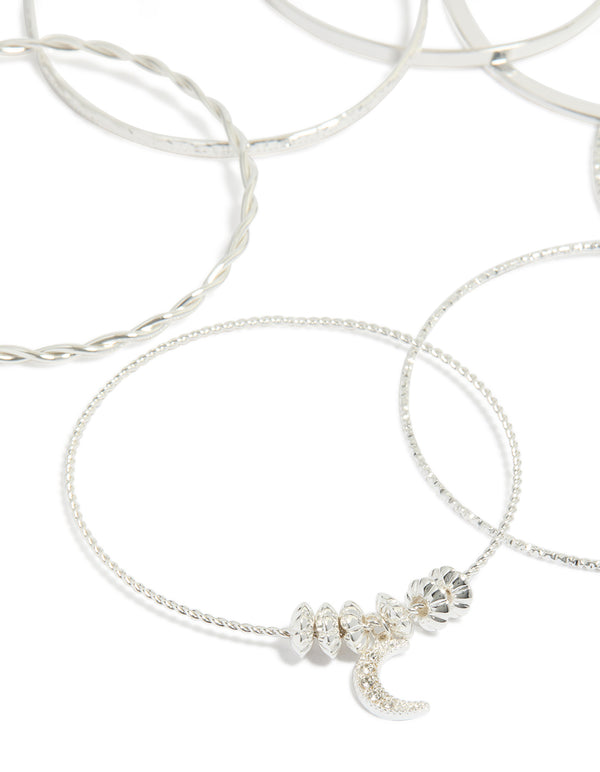 Crafted from silver with celestial charm bangles featuring diamante moon and star accents in a statement 7-pack set close up view