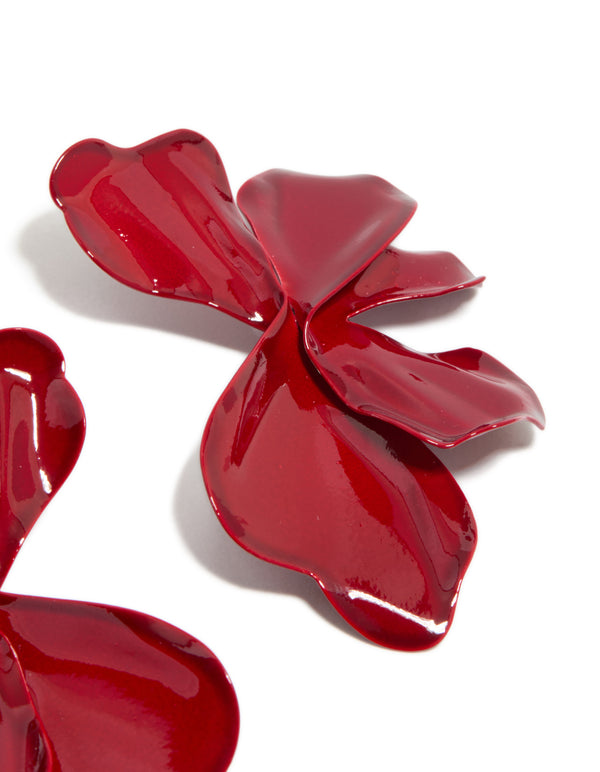 Crafted with large statement stud earrings showcasing floral petal design in red coated metal detail view