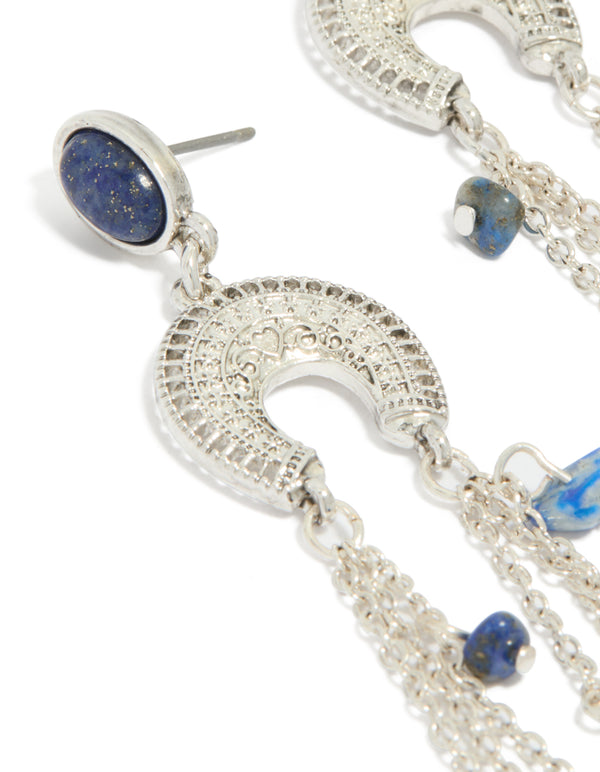 Showcasing statement silver drop earrings with crescent design, beaded details, semi precious stones and tassel accents close up view