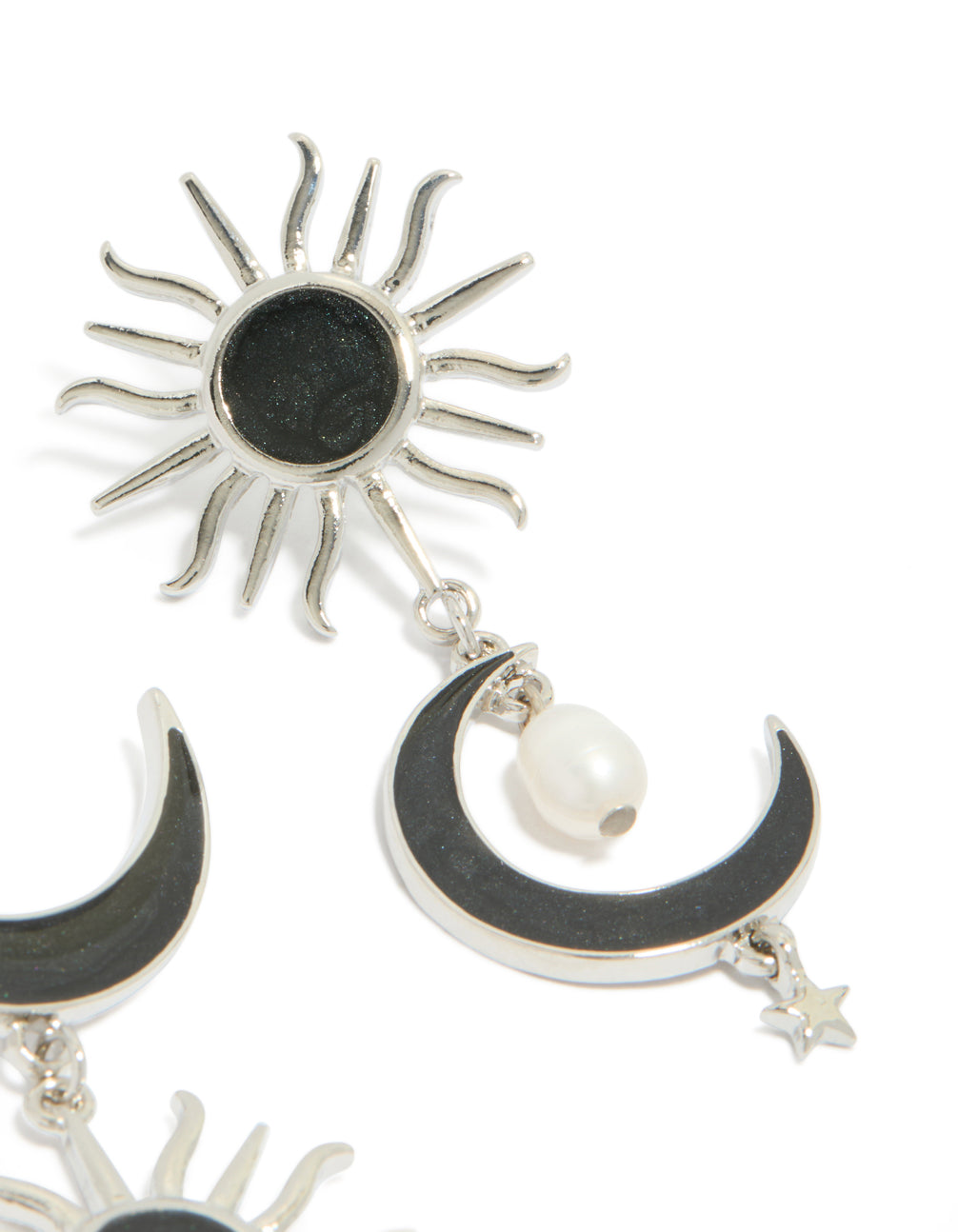 Highlighting statement silver black drop earrings featuring moon and sun celestial design with pearl accents in post detail view