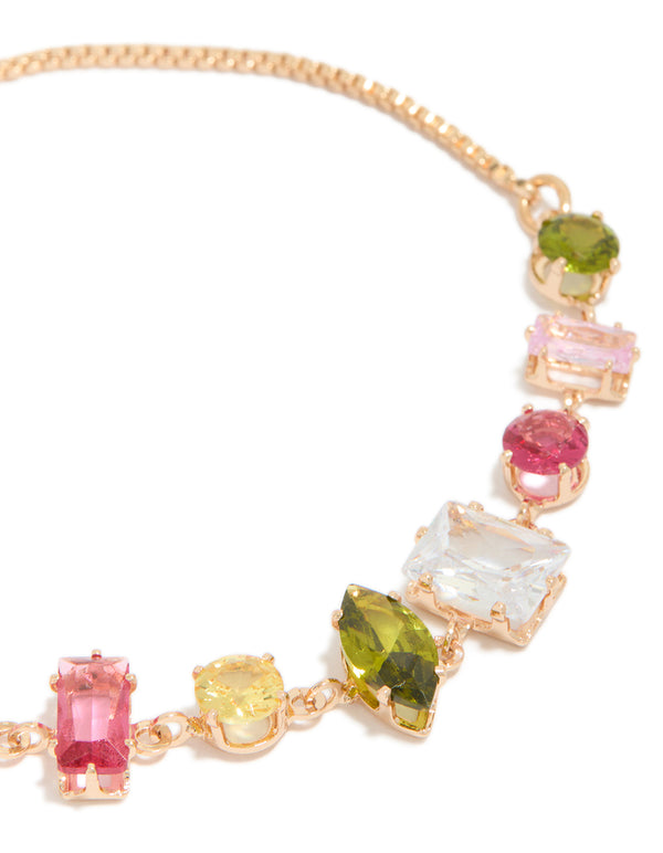 Stunning gold pink and green mismatched cubic zirconia toggle bracelet close up view