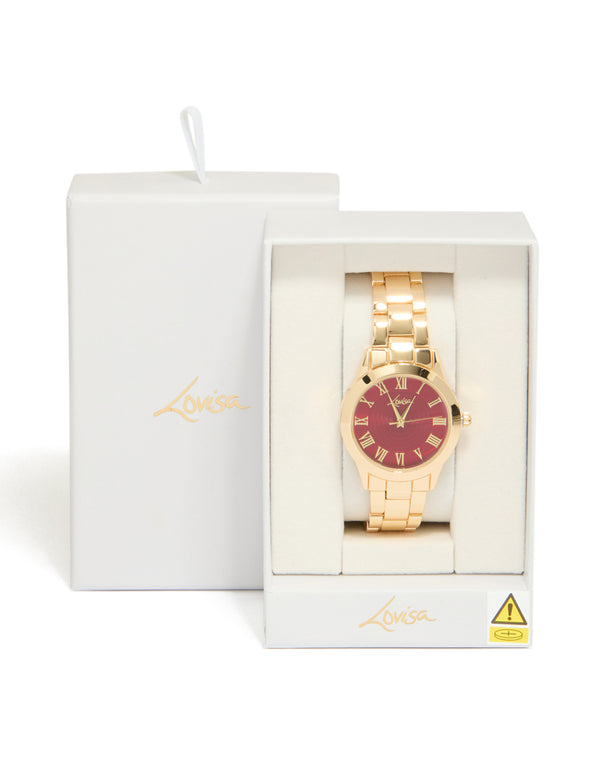 Stylish women's analog watch with brown roman numeral dial, round shape, link band strap in gold for formal occasions view