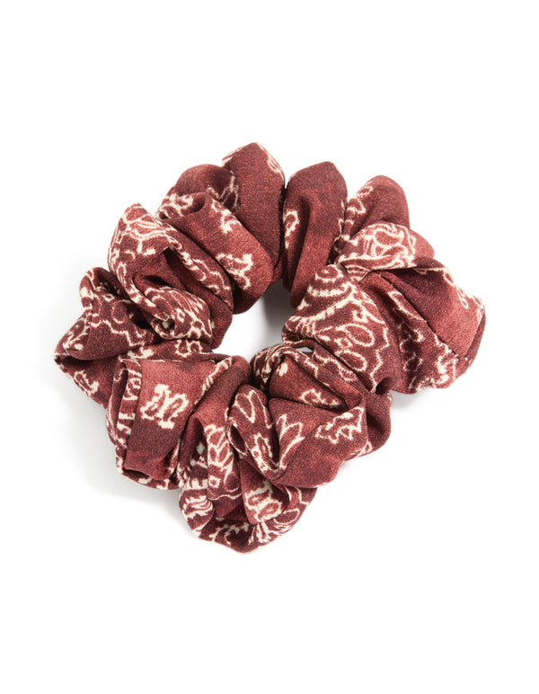 Discover a statement fabric scrunchie featuring paisley design in maroon and beige tones front view