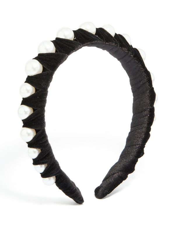 Showcasing a black fabric and pearl wrap headband with solid print in white front view