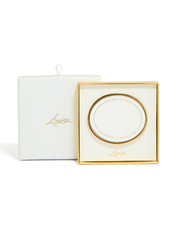 Showcasing a waterproof gold plated stainless steel hinged bangle featuring cubic zirconia inlay with white enamel detailing front view