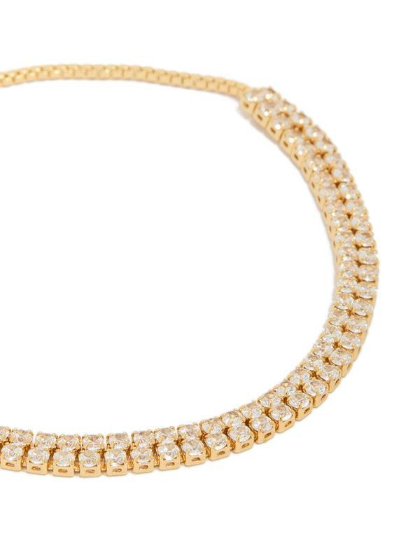 Delicate thin double cubic zirconia tennis toggle bracelet crafted from gold plated material close up view