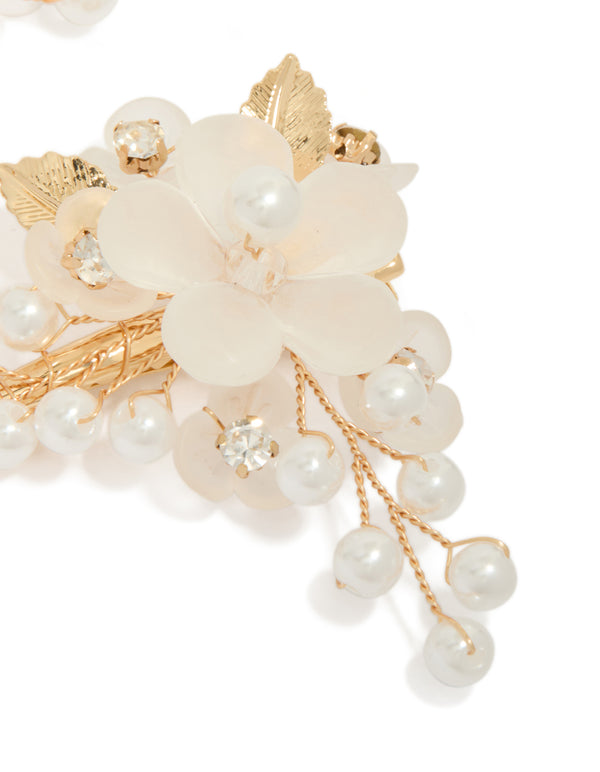 Crafted from gold plated material, this pearl and acrylic flower clip with leaf and floral details in ivory and white detail view