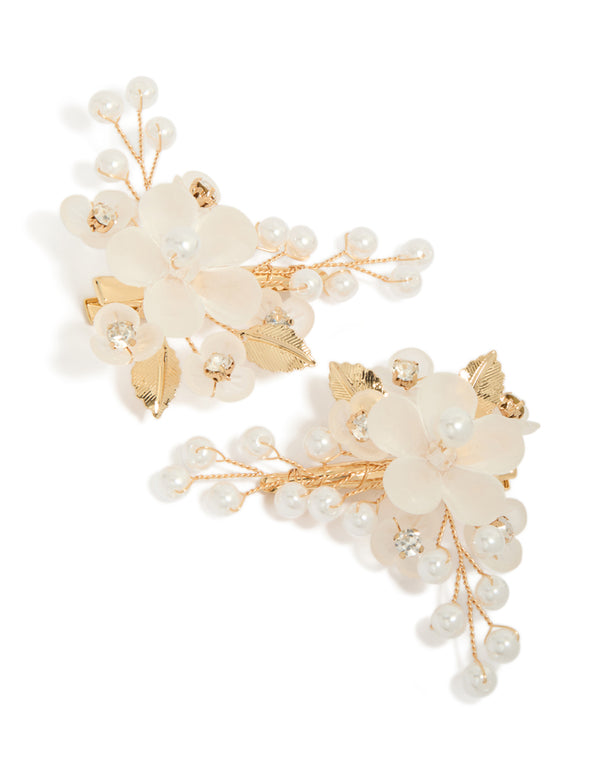Presenting a gold plated pearl and acrylic flower clip featuring leaf accents and floral details in ivory and white front view