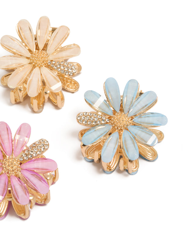 Featuring glitter floral print 3-pack gold pastel daisy claw clips in pink, powder blue, and peachpuff side view