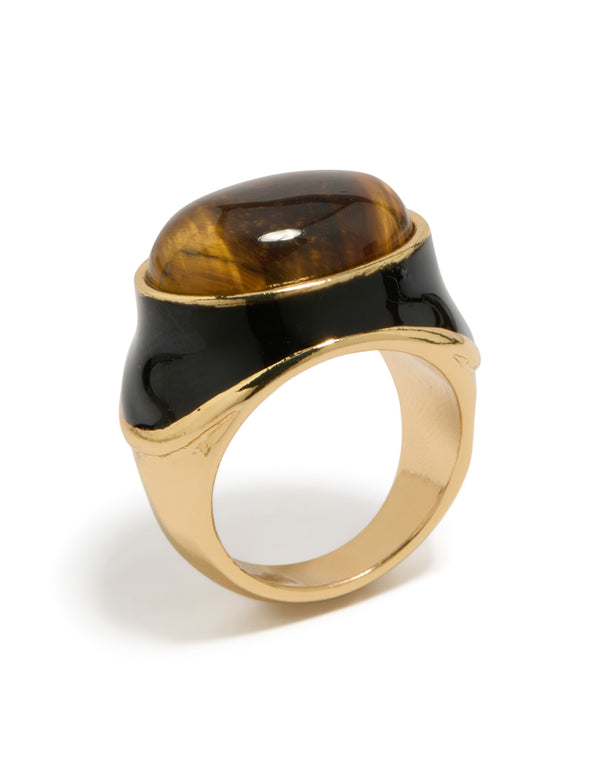 Featuring a gold plated brown stone and black enamel ring in statement style close up view