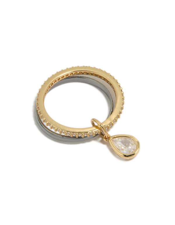 Showcasing a mixed metal plated cubic zirconia band and stacked ring with charm featuring gold and silver tones and white stones close up view
