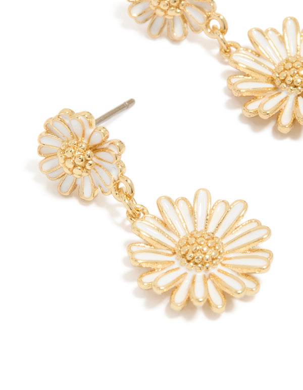 Showcasing gold plated white enamel double daisy drop earrings with floral close up view
